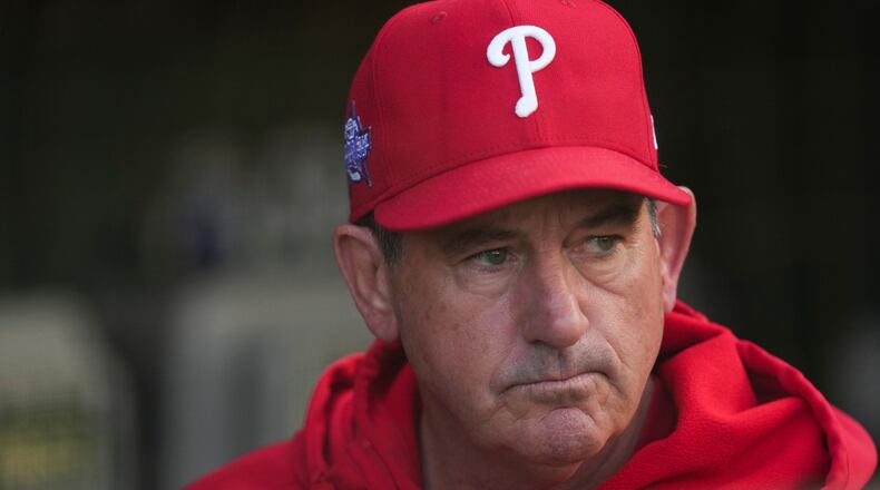 Philadelphia Phillies manager Rob Thomson (49) stands in the dugout before a baseball game against the Chicago Cubs, Wednesday, April 22, 2026, in Chicago. (AP Photo/Erin Hooley)