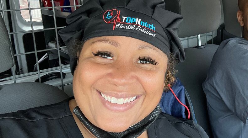 Top Notch Health Solutions’ Paula Richardson pictured in her mobile testing van with a fellow staffer, Quanteria Morton Jr. (Courtesy of Paula Richardson)