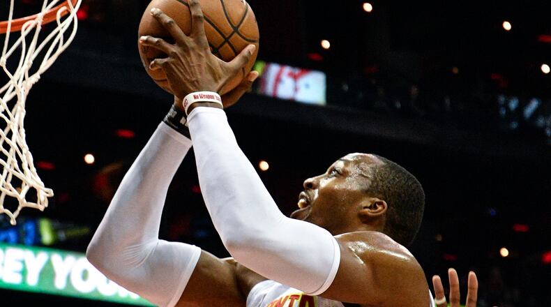 Atlanta Hawks center Dwight Howard (8) shoots as Philadelphia 76ers center Jahlil Okafor defends during the second half of an NBA basketball game, Saturday, Jan. 21, 2017, in Atlanta. Atlanta won 110-93. (AP Photo/John Amis)