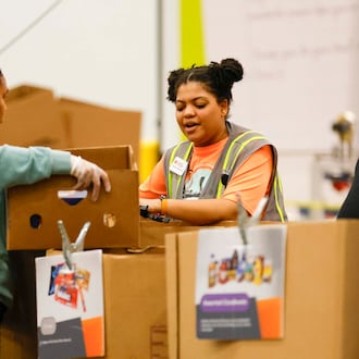 Volunteers pack food boxes at the Hunger Action Center at the Atlanta Community Food Bank Distribution Center. Requests for assistance have increased substantially since SNAP benefits have been cut off because of the government shutdown. (Miguel Martinez/AJC)
