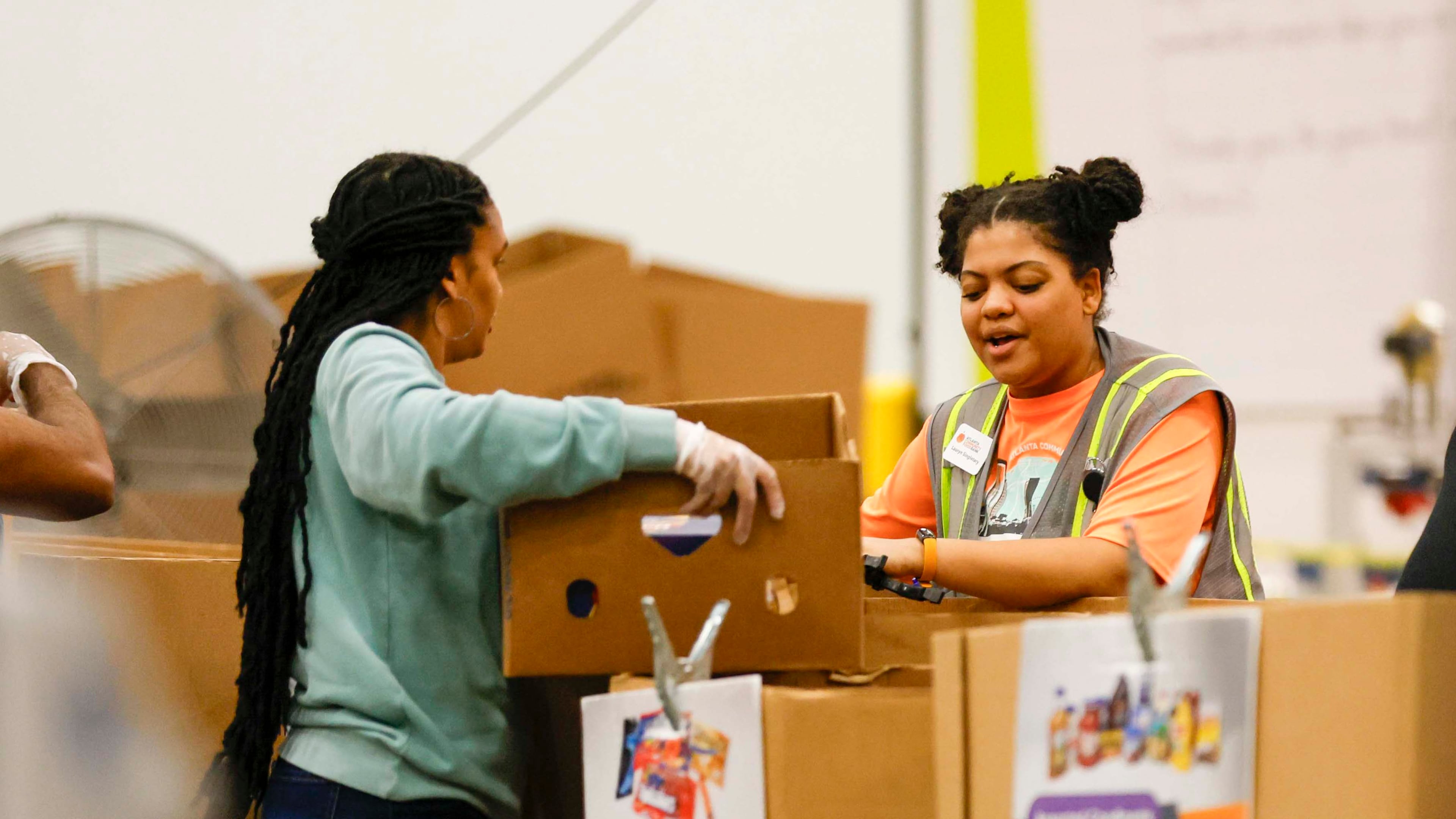 Volunteers pack food boxes at the Hunger Action Center at the Atlanta Community Food Bank Distribution Center. Requests for assistance have increased substantially since SNAP benefits have been cut off because of the government shutdown. (Miguel Martinez/AJC)