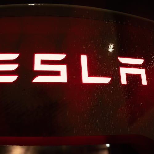 A Tesla electric vehicle charger is seen at a charging station on Wednesday, April 15, 2026, in Portland, Ore. (AP Photo/Jenny Kane)