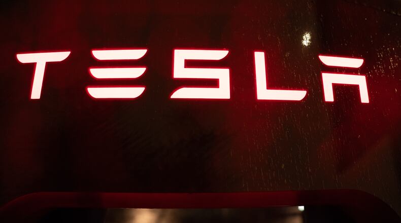 A Tesla electric vehicle charger is seen at a charging station on Wednesday, April 15, 2026, in Portland, Ore. (AP Photo/Jenny Kane)