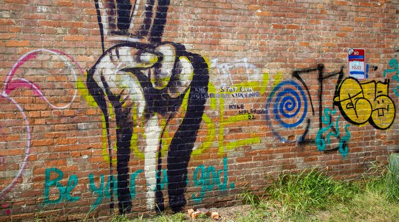 Kyle Holbrook, 44, completed this mural of a peace sign on Saturday, July 30, to raise awareness about gun violence and provide a memorial for victims' families.