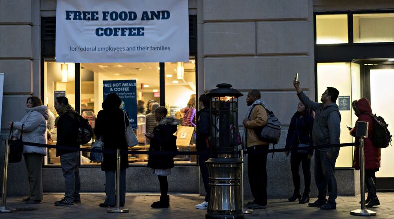 Customers wait in line outside a restaurant opened for federal workers and their families during a partial government shutdown in Washington, D.C., on Jan. 17. ANDREW HARRER / BLOOMBERG