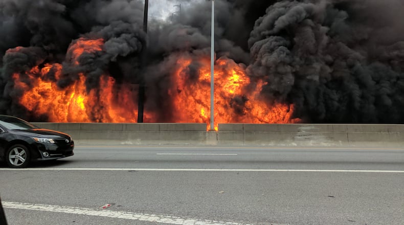MARCH 30, 2017 Motorists pass by a colossal fire that caused the collapse of I-85 in Midtown at the height of rush hour Thursday evening, stranding thousands of motorists and shuttering a main gateway to the heart of Atlanta indefinitely. The northbound lanes of I-85 collapsed at Piedmont Road, just south of Ga. 400, about 7 p.m. as firefighters battled an intense blaze beneath the interstate. Authorities said they did not know the cause of the fire - but the Georgia State Patrol said there was no evidence of a terrorist attack. Courtesy Jackson Klinefelter