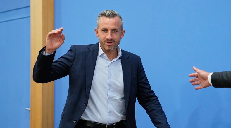 Top candidate for the Saxony-Anhalt state elections Ulrich Siegmund, center, attends a press conference in Berlin, Germany, Monday, Sept. 7, 2026. (AP Photo/Ebrahim Noroozi)