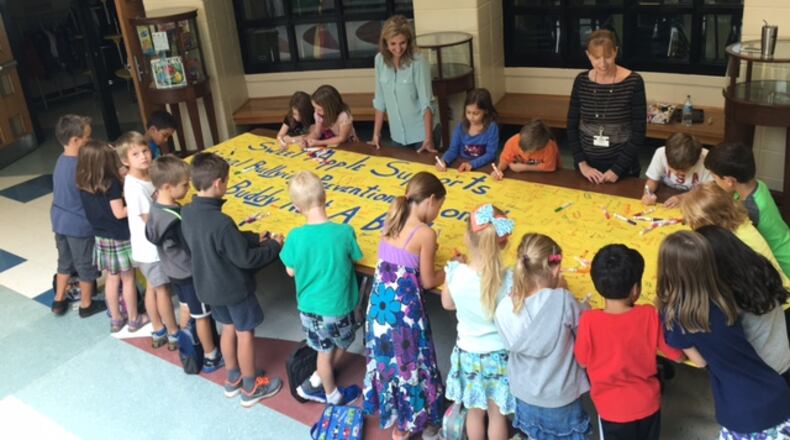 Sweet Apple Elementary students sign the school’s banner promoting an anti-bullying message.