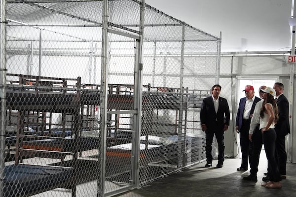 President Donald Trump, Gov. Ron DeSantis, R-Fla., and Homeland Security Secretary Kristi Noem, and others, tour "Alligator Alcatraz," a new migrant detention facility at Dade-Collier Training and Transition facility, Tuesday, July 1, 2025, in Ochopee, Fla. (AP Photo/Evan Vucci)