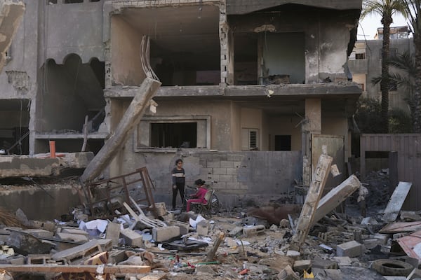 Palestinians inspect a house destroyed by an Israeli airstrikes in Deir al-Balah, Gaza, Wednesday, May 21, 2025. (AP Photo/Abdel Kareem Hana)