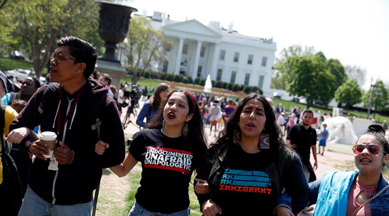 WASHINGTON, DC - APRIL 13: Demonstrators lock arms and chant during the "Stand Up to Trump" rally outside the White House April 13, 2017 in Washington, DC. Youth activists from around the country gathered to protest President Donald Trump's immigration policies.