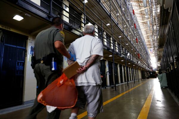 A death row inmate is escorted back to his East Block cell after spending time in the yard at San Quentin State Prison. (Gary Coronado/Los Angeles Times/TNS)