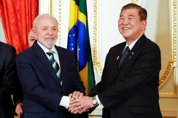Brazilian President Luiz Inacio Lula da Silva, left, and Japanese Prime Minister Shigeru Ishiba shake hands during the Cooperation Document Exchange Ceremony at the Akasaka Palace State Guest House in Tokyo, Wednesday, March 26, 2025. (Rodrigo Reyes Marin/Pool Photo via AP)