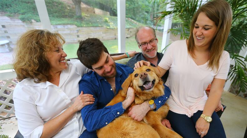 The Schultz family Jeanne, Josh, Jeff and Sierra with their dog Lilly at their Johns Creek home. When Josh went into treatment for opiate addiction the family got a puppy, Lilly, as part of a distraction and a symbol of co-dependency. (Curtis Compton/ccompton@ajc.com)