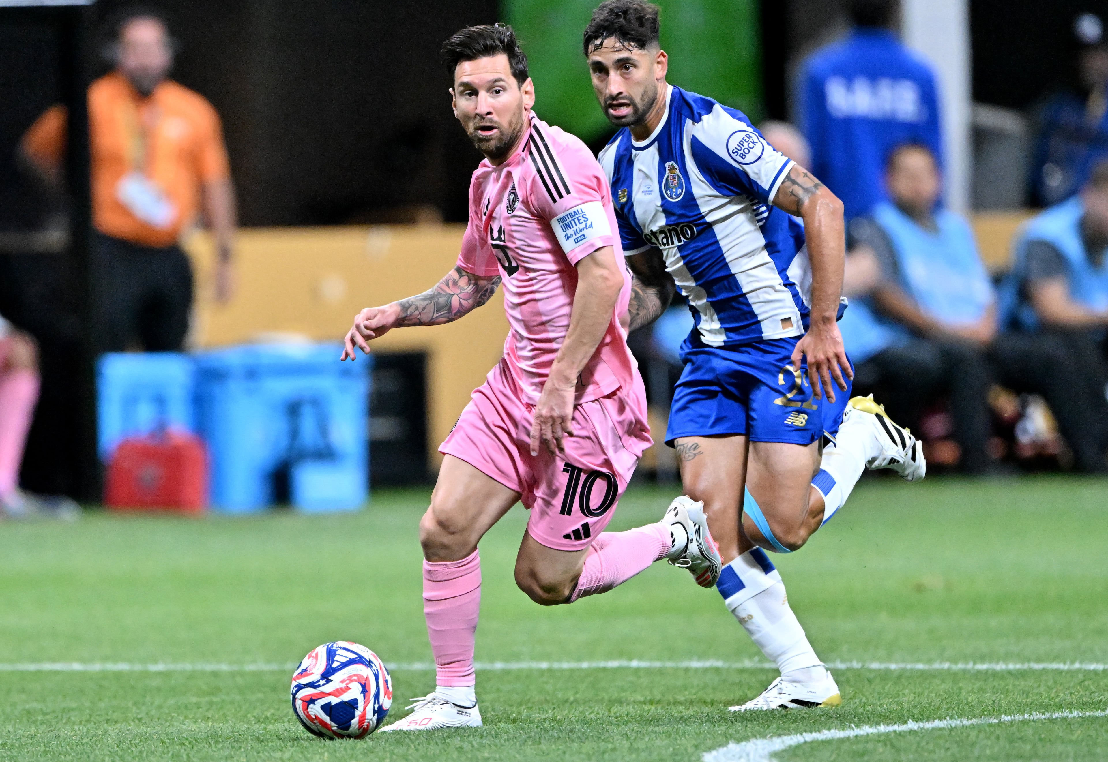 Inter Miami forward Lionel Messi (10) works with the ball pst Porto’s Alan Varela (22) during Club World Cup group A soccer match at Mercedes-Benz Stadium, Thursday, June 19, 2025, in Atlanta. (Hyosub Shin / AJC)
