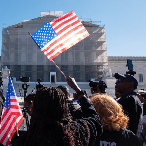 Voting rights activists gather outside the Supreme Court in Washington, early Wednesday, Oct. 15, 2025, as the justices prepare to take up a major Republican-led challenge to the Voting Rights Act, the centerpiece legislation of the Civil Rights Movement. (AP Photo/Cliff Owen)