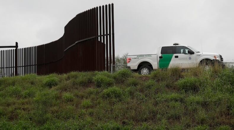 This Nov. 13, 2016, file photo shows a U.S. Customs and Border Patrol agent passes along a section of border wall in Hidalgo, Texas.  (AP Photo/Eric Gay, File)