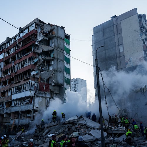 Rescue workers clear the rubble of a house heavily damaged after a Russian strike on a residential neighborhood in Kyiv, Ukraine, on Thursday, May 14, 2026. (AP Photo/Evgeniy Maloletka)