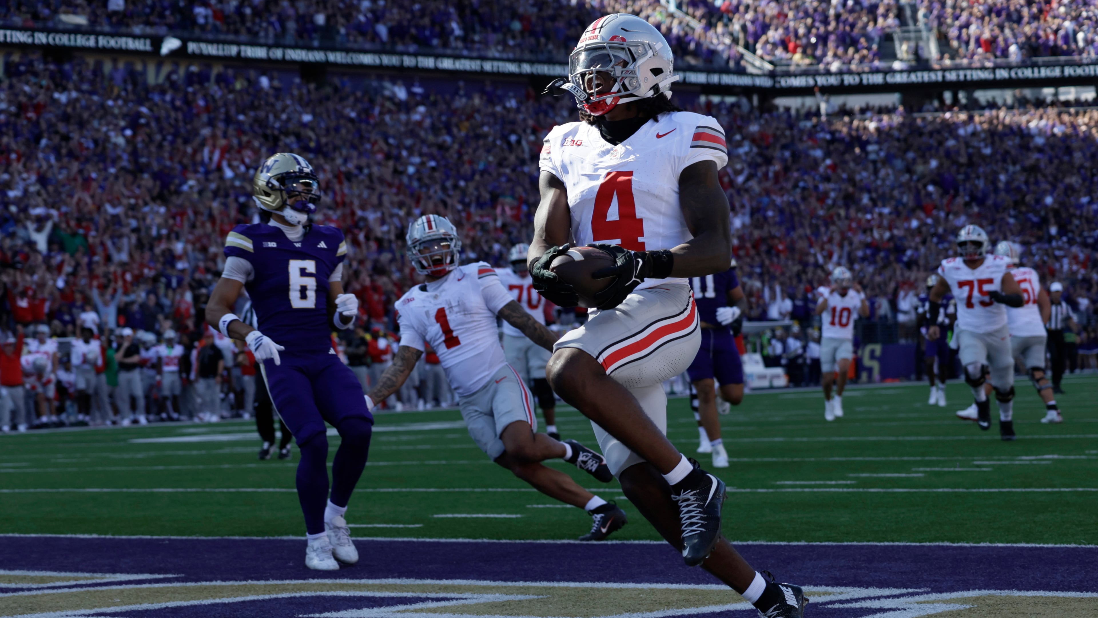 Ohio State wide receiver Jeremiah Smith (4) scores on a pass run play against the Washington during the first half of an NCAA college football game, Saturday, Sept. 27, 2025, in Seattle. (AP Photo/John Froschauer)
