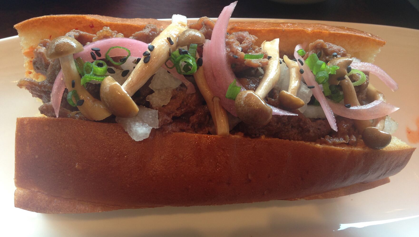 A bulgogi roll with pickled mushrooms and kimchi remoulade