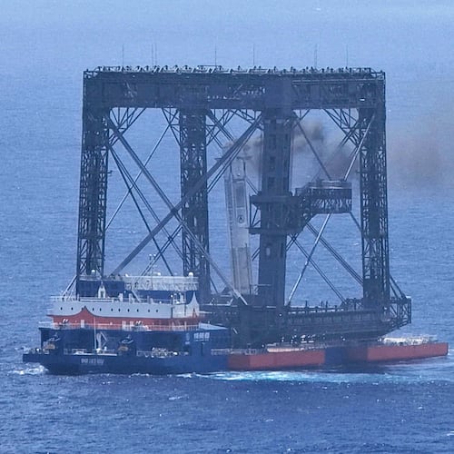 In this photo released by Xinhua News Agency, a drone photo shows the successful capture of the returned first stage of Long March-10B carrier rocket on a seaborne platform via a net-capture system near Wenchang in southern China's Hainan province on Friday, July 10, 2026. (Xing Guangli/Xinhua News Agency via AP)