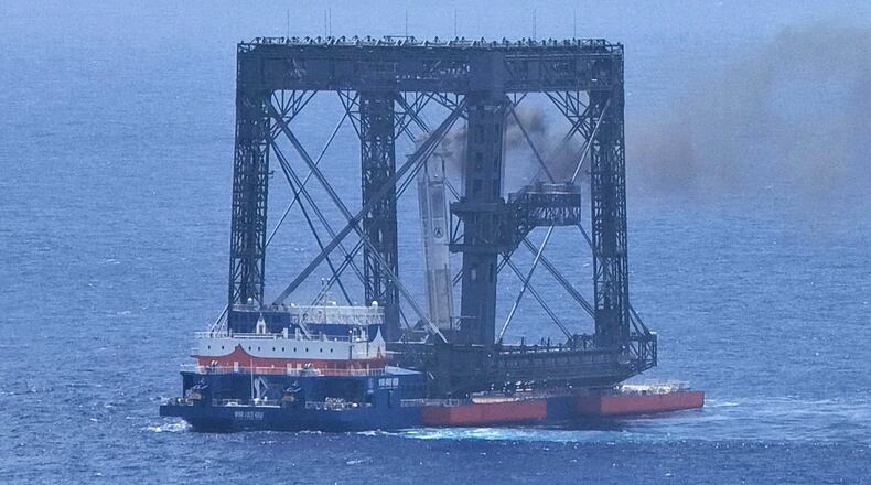 In this photo released by Xinhua News Agency, a drone photo shows the successful capture of the returned first stage of Long March-10B carrier rocket on a seaborne platform via a net-capture system near Wenchang in southern China's Hainan province on Friday, July 10, 2026. (Xing Guangli/Xinhua News Agency via AP)