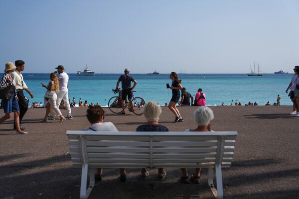 People enjoy the beach as vessels sail during the "Ocean Wonders" event in honor of World Oceans Day ahead of the U.N. Ocean Conference on Sunday, June 8, 2025, in Nice, France. (AP Photo/Annika Hammerschlag)