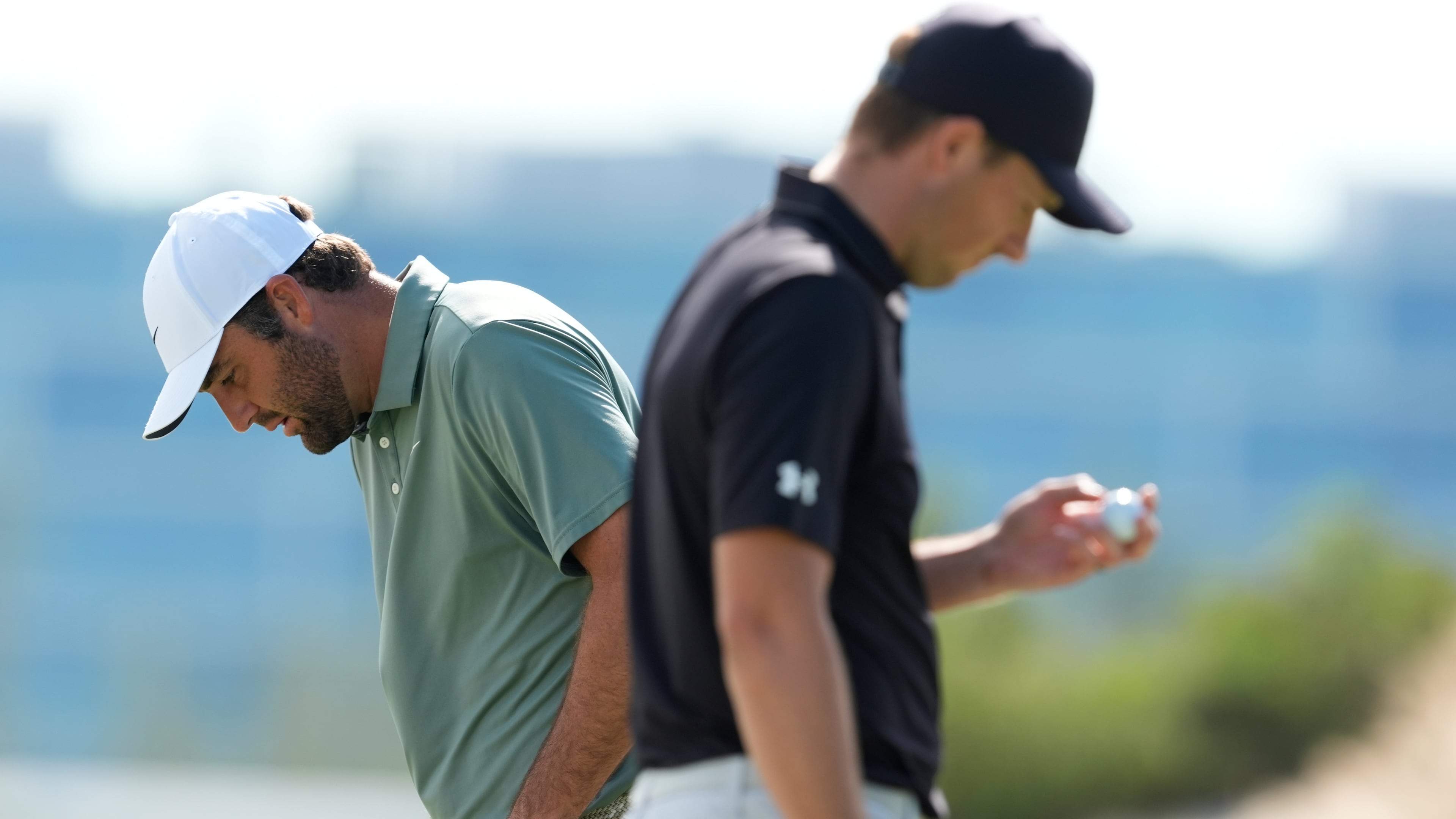 Scottie Scheffler, left, walks near Jordan Spieth, both of the United States, on the third green during the first round of the Hero World Challenge PGA Tour at the Albany Golf Club, in New Providence, Bahamas, Thursday, Dec. 4, 2025. (AP Photo/Fernando Llano)