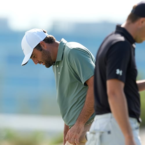 Scottie Scheffler, left, walks near Jordan Spieth, both of the United States, on the third green during the first round of the Hero World Challenge PGA Tour at the Albany Golf Club, in New Providence, Bahamas, Thursday, Dec. 4, 2025. (AP Photo/Fernando Llano)