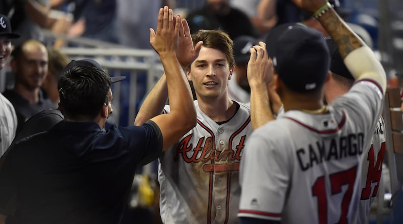 Pitcher Max Fried is congratulated by Braves teammates after scoring as a pinch runner on a double by Ender Inciarte during the 10th inning Sunday, May 5, 2019, in Miami.