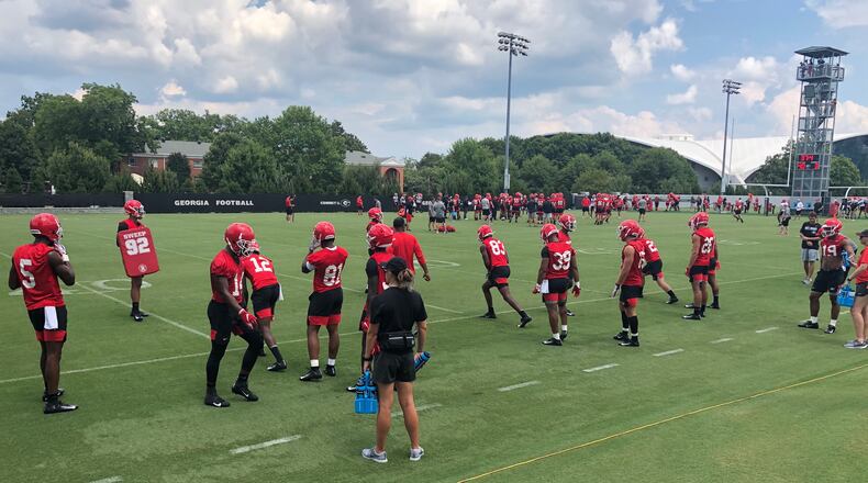 Receivers coach Cortez Hankton (center) is hard to spot among his 18 charges as they run through drills on Woodruff Practice Fields during preseason camp on the UGA campus in Athens this past weekend.