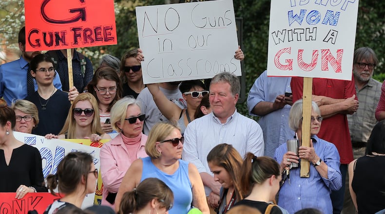 Students, faculty, staff and local residents hold a protest against campus carry legislation at the University of Georgia Arch on Tuesday, March 21, 2017, in Athens. Curtis Compton/ccompton@ajc.com