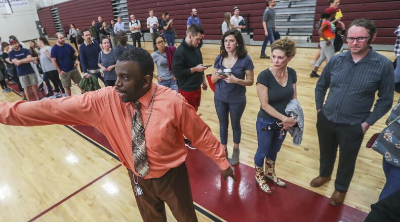 Poll manager Melvin Davis Jr. directed traffic as the lines grew and the wait increased to over an hour to vote in November at Henry W. Grady High School in Atlanta. JOHN SPINK/JSPINK@AJC.COM