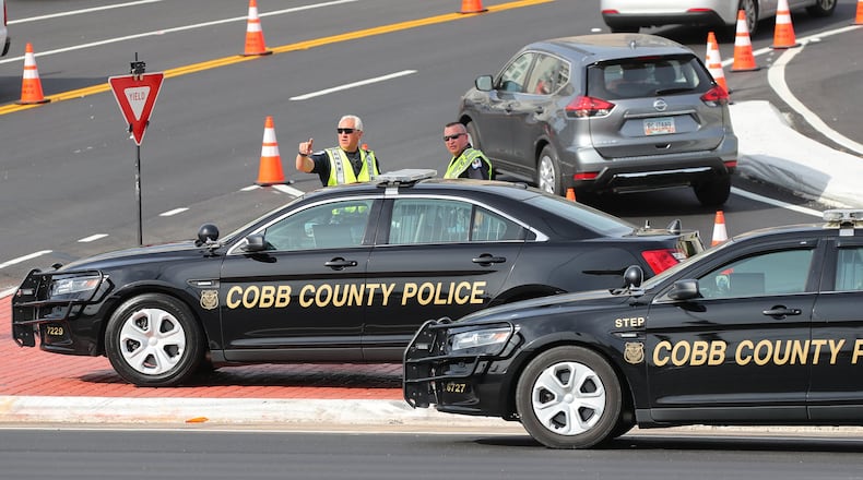 Cobb Police Department officers work traffic control at the intersection of Spring Road and Circle 75 Parkway outside the SunTrust Park development during the Braves game on Wednesday, May 3, 2017, in Atlanta. CURTIS COMPTON/CCOMPTON@AJC.COM