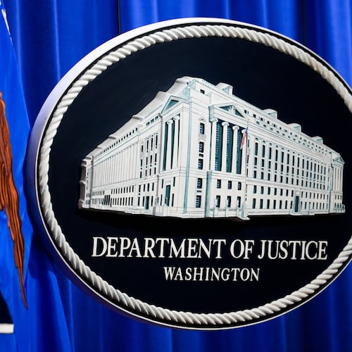 The U.S. Department of Justice logo is before a news conference, Monday, May 4, 2026, in Washington. (AP Photo/Julia Demaree Nikhinson)