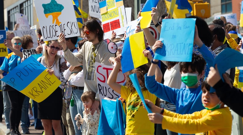 A crowd gathers along Centennial Park Drive near CNN Center during a rally organized by the Ukrainian Community of Atlanta on Saturday, March 5, 2022. (Photo by Steve Schaefer for The Atlanta Journal-Constitution)