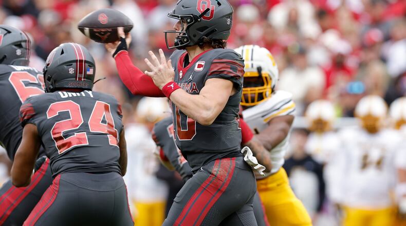 Oklahoma quarterback John Mateer (10) passes against Missouri during the first half of an NCAA college football game Saturday, Nov. 22, 2025, in Norman, Okla. (AP Photo/Alonzo Adams)