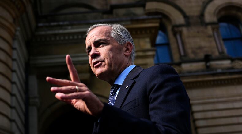 Canadian Prime Minister Mark Carney speaks with members of the media as he arrives at the Office of the Prime Minister and Privy Council in Ottawa, on Tuesday, Sept. 1, 2026. (Justin Tang/The Canadian Press via AP)