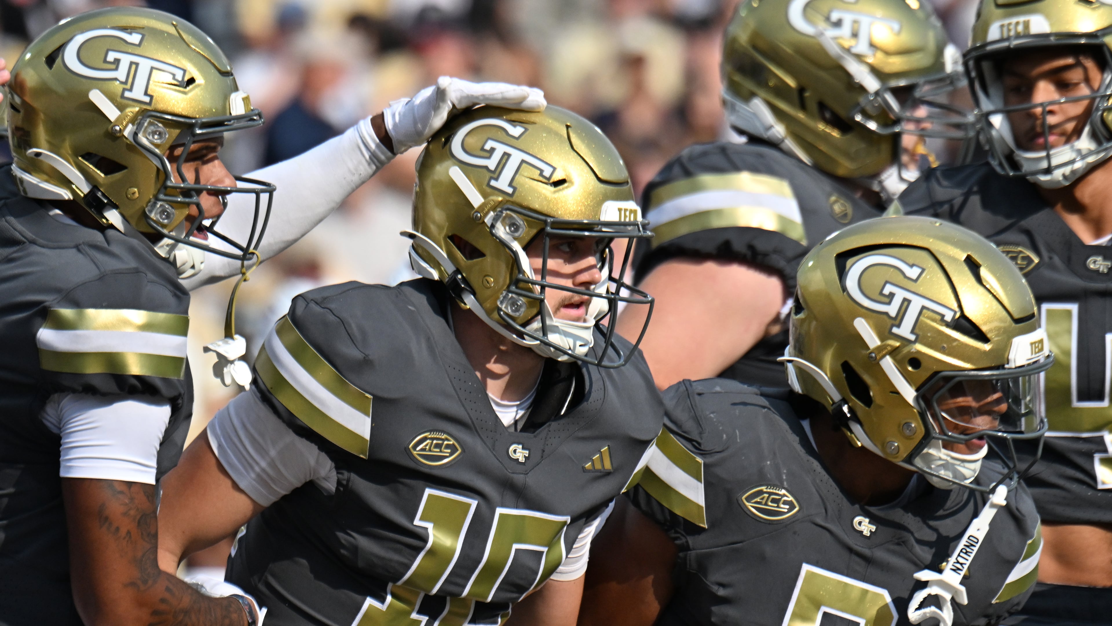 Georgia Tech quarterback Haynes King celebrates with teammates after scoring a touchdown during the first half of an NCAA college football game at Georgia Tech's Bobby Dodd Stadium, Saturday, Sept. 20, 2025, in Atlanta. (Hyosub Shin/AJC)