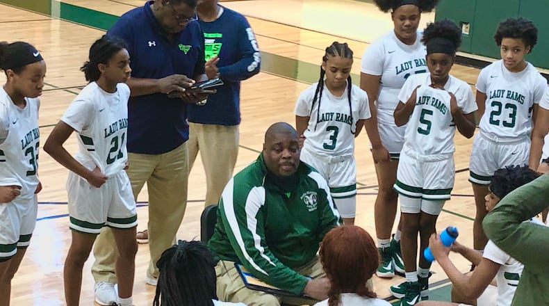 Arabia Mountain coach Jerry Jackson talks to his girls basketball team during a timeout.