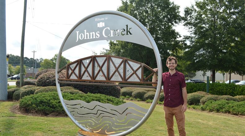 Johns Creek Convention and Visitors Bureau installed a gateway marker last fall at the corner of Kimball Bridge Road and State Bridge Road, shown here with the artist, William Massey.
(Courtesy Johns Creek Convention and Visitors Bureau)