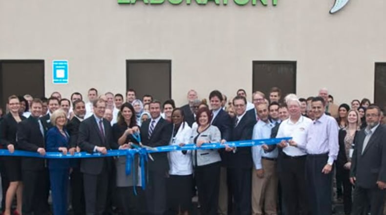 Former U.S. Rep Jack Kingston poses with senior employees of Confirmatrix Dec. 6, 2013, in Lawrenceville. The company was founded with help from Khalid Satary, a Gwinnett businessman under a U.S. deportation order stemming from a conviction for music piracy. GWINNETTFORUM.COM