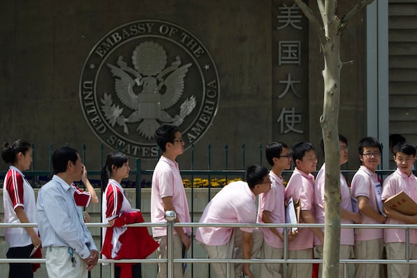 FILE - Chinese students wait outside the U.S. Embassy for their visa application interviews, in Beijing on May 2, 2012. (AP Photo/Alexander F. Yuan, File)