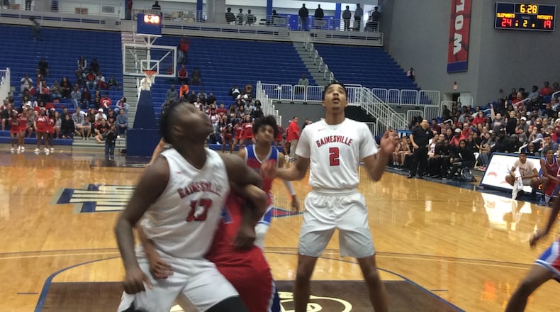 Gainesville's Xavier Bledson (13) and Jarrel Rosser (2) work for a rebound Saturday in the first half of their Class AAAAAA semifinal against Heritage-Conyers at the University of West Georgia.