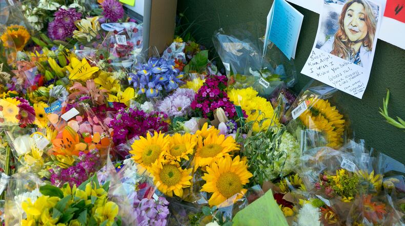 A note with the likeness of Trader Joe's employee Melyda Corado is surrounded by flowers, candles and support notes growing on the sidewalk outside the Silver Lake Trader Joe's store in Los Angeles Monday, July 23, 2018. Trader Joe's worker Corado was shot and killed in an exchange of gunfire between a suspect and the police at the store. Grieving family members, co-workers and customers on Sunday remembered Corado as lively, hardworking and always smiling. (AP Photo/Damian Dovarganes)