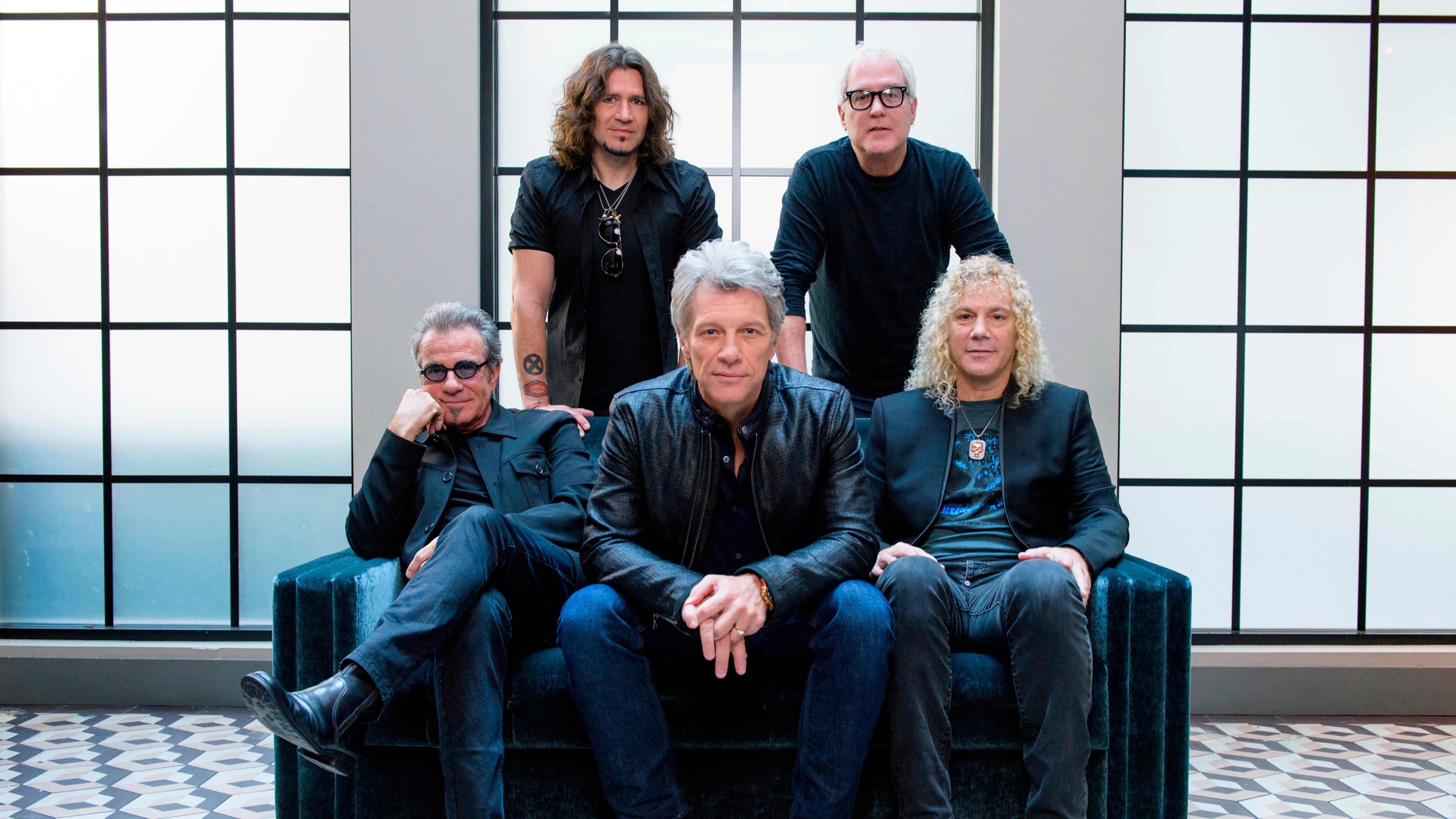FILE - Members of Bon Jovi front row from left, Tico Torres, Jon Bon Jovi, David Bryan, back row from left, Phil X, and Hugh McDonald pose for a portrait in New York on Oct. 19, 2016. (Photo by Drew Gurian/Invision/AP, File)