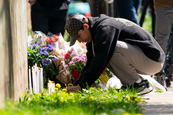 A member of the public lights a candle near the scene where a vehicle drove into crowd on Saturday at a street festival killing multiple people, in Vancouver, British Columbia, Sunday, April 27, 2025. (Rich Lam/The Canadian Press via AP)