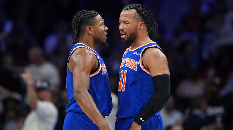 New York Knicks' Miles McBride, left, and Jalen Brunson celebrate during the first half of Game 4 against the Philadelphia 76ers in a second-round NBA basketball playoffs series Sunday, May 10, 2026, in Philadelphia. (AP Photo/Matt Slocum)