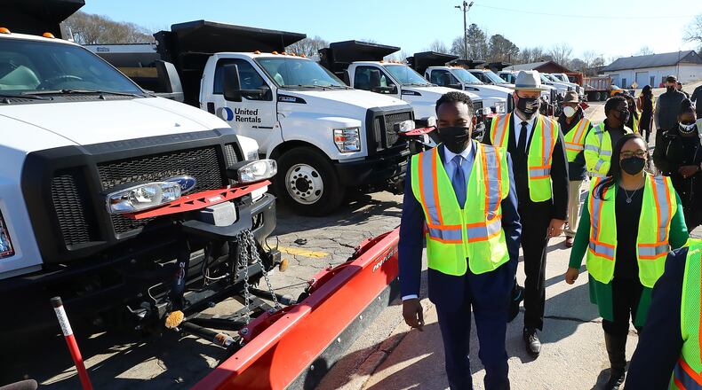 Atlanta Mayor Andre Dickens (left), Congresswoman Nikema Williams (right) and Atlanta Department of Transportation Commissioner Josh Rowan (center) tour the ATLDOT North Avenue facility following a press briefing on how the Infrastructure Investment and Jobs Act will help Atlanta on Thursday, Jan. 27, 2022, in Atlanta.   (Curtis Compton / Curtis.Compton@ajc.com)
