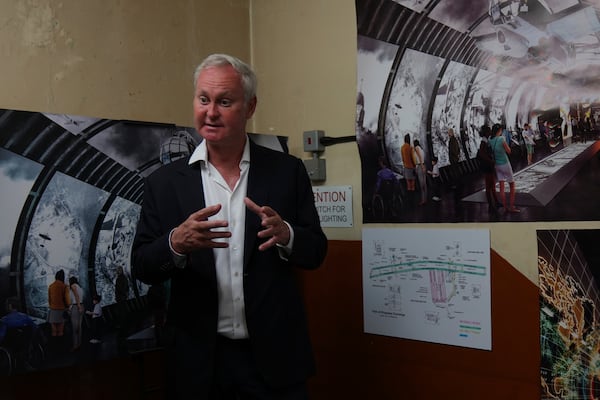Angus Murray, CEO of The London Tunnels, gestures as he shows photos and diagrams relating to the history of the tunnels speaking during a press tour in London, Thursday, June 19, 2025. (AP Photo/Joanna Chan)